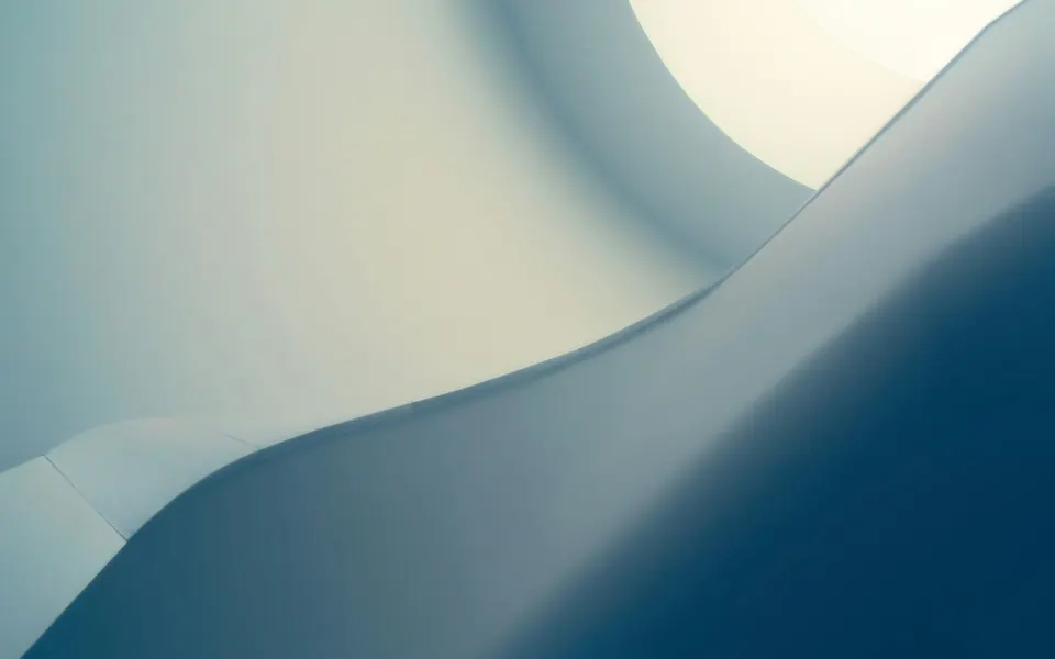Curving architectural forms in soft blue light